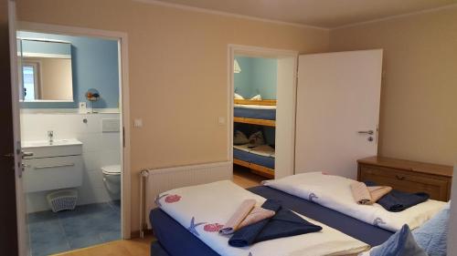 a small room with two beds and a bathroom at Geert-Bakker-Strasse Ferienwohnung Tamino in Borkum