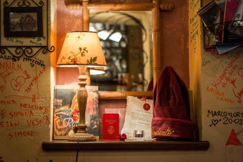 a lamp sitting on a window sill next to a mirror at Rooms & Restaurant Ostarija in Dolenjske Toplice