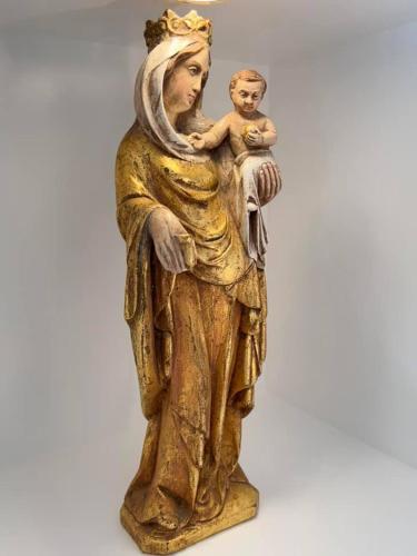 a gold statue of a woman holding a baby at Le Moulin de L'Abbaye Notre Dame du Vivier in Namur