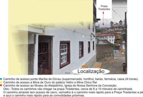 un'immagine di un edificio bianco con un cartello che legge le scale di Casa perto de tudo, pra você ter ótima experiência. Bora Conhecer Ouro Preto.... a Ouro Preto