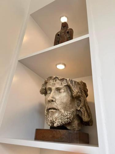 a statue of a head on a shelf at Le Moulin de L'Abbaye Notre Dame du Vivier in Namur