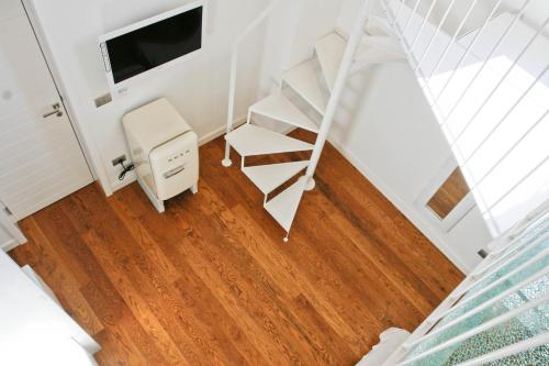 a room with a chair and a desk and a mirror at Sui Tetti Luxury Rooms in Lecce