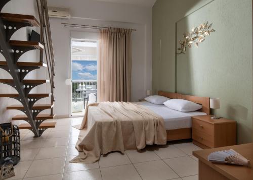 a bedroom with a bed and a staircase and a stair case at Agrelia in Agios Nikolaos