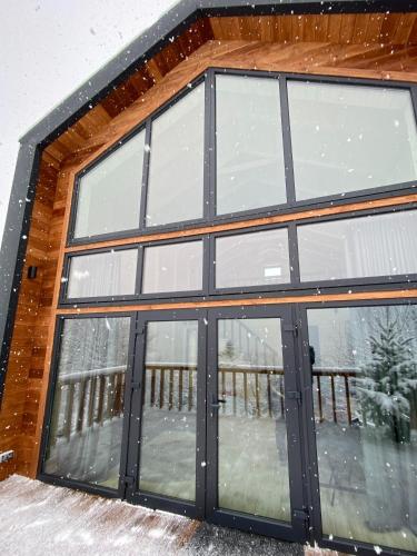 a garage with sliding glass doors in the snow at ЗаҐора in Tatariv