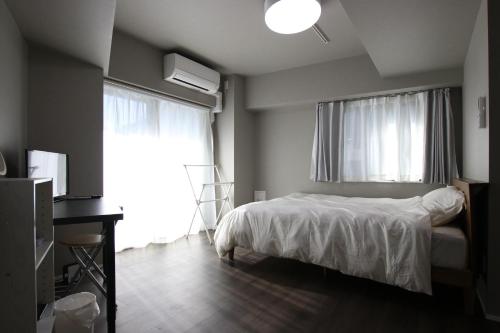 a bedroom with a bed and a large window at Kamatas STAY 京急蒲田駅 徒歩5分 in Tokyo