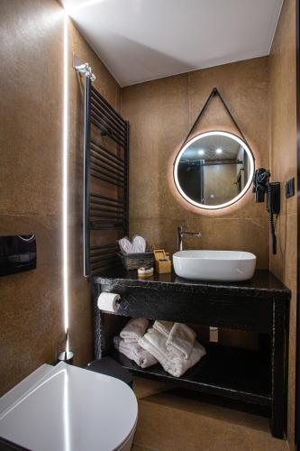 a bathroom with a sink and a mirror at Adryades luxury apartments in Metsovo