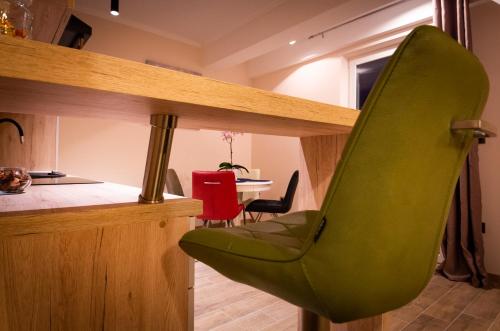 a green chair in a kitchen with a table at Villa Ragusa in Dubrovnik