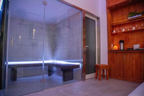 a glass shower with a bench in a room at B&B Del Centro e SPA in Partinico