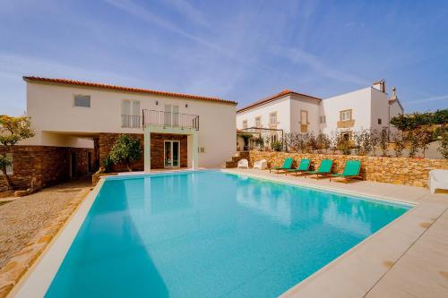 a swimming pool in front of a house at Casa de Valcova - Boutique Hotel in Canedo