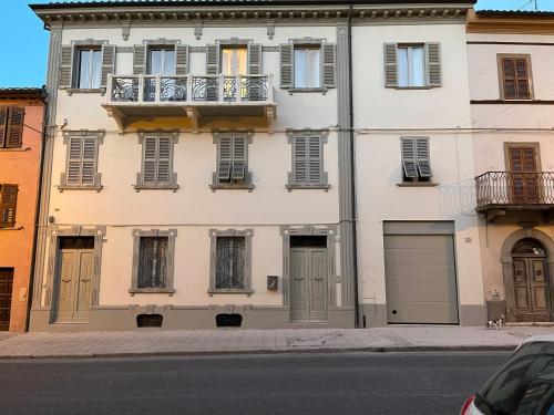 a white building with windows and a balcony at PalazzoRegina in Pergola