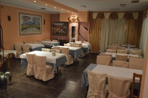 a dining room with white tables and chairs at Artemis in Paralia Katerinis