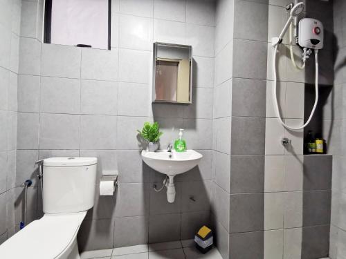 a bathroom with a toilet and a sink at 3 Astetica Residences The Mines 4BR WiFi Netflix Lake View in Seri Kembangan