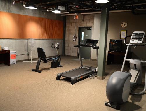 a gym with several exercise equipment in a room at The Great Falls Inn By Riversage in Great Falls