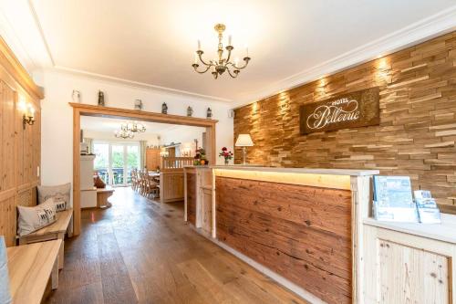 a large room with a wooden wall and a restaurant at Hotel Bellevue in Bad Wiessee