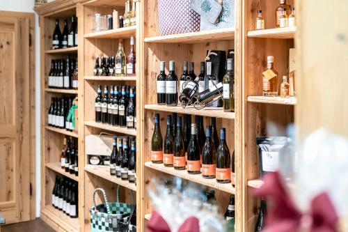 a shelf filled with lots of bottles of wine at Hotel Bellevue in Bad Wiessee