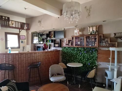a restaurant with a bar with chairs and a table at HOTEL IVATO , Airport in Antananarivo