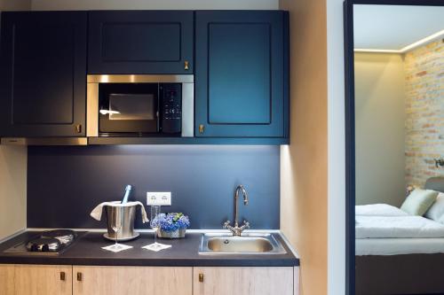 a kitchen with a sink and a microwave at Heritage Home Apartments in Budapest