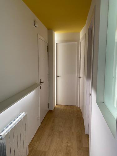 an empty room with a hallway with a door at Ca l'Aiet in La Pobla de Lillet