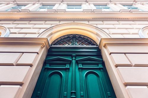 a green door on the side of a building at Heritage Home Apartments in Budapest