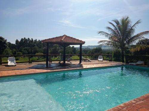 a swimming pool with a gazebo and a swimming pool at POUSADA SAKURA in Patrimônio São Sebastião