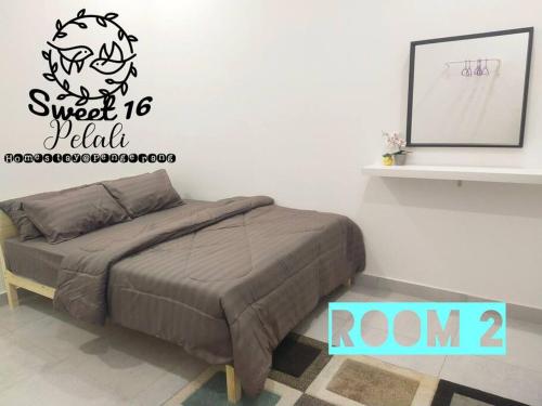 a bedroom with a bed and a wall at Sweet 16 Pelali Homestay Pengerang (Wifi/Netflix) in Pengerang