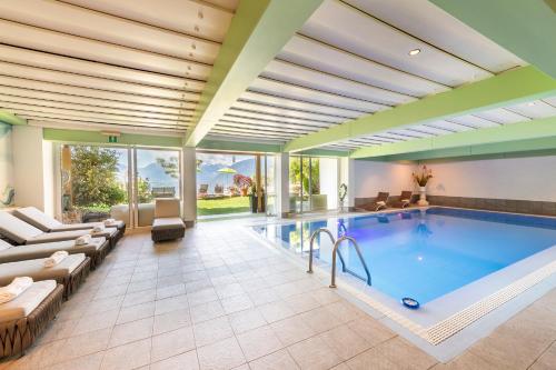 a pool in a house with a large room at Hotel Moserhof in Schenna