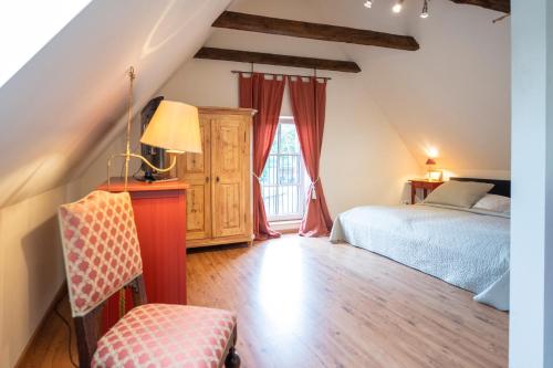a attic bedroom with a bed and a window at Gut Basthorst in Basthorst