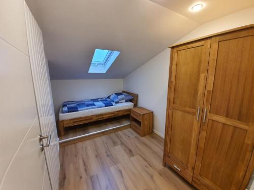 a small bedroom with a bed and a skylight at Handwerkerwohnung - Monteurunterkunft in Crumstadt
