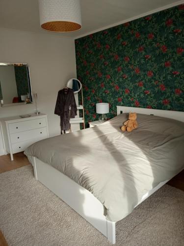 a bedroom with a bed with a teddy bear on it at La Porte Rose in Rochesson