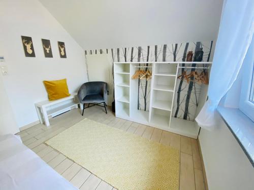 a walk in closet with a blue chair and a rug at Ferienhäuser mit Seeblick direkt am Plauer See in Plau am See