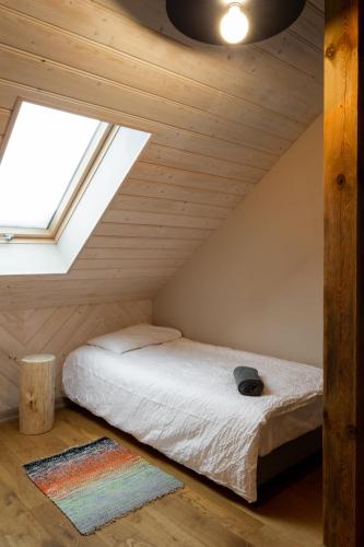 a bedroom with a bed in a attic at Ķestermuiža in Alūksne