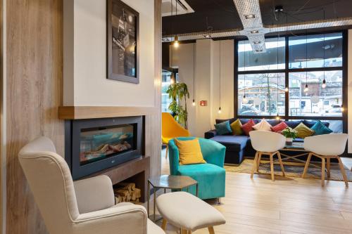 a living room with chairs and a fireplace at Campanile Epinal Centre - Gare in Épinal