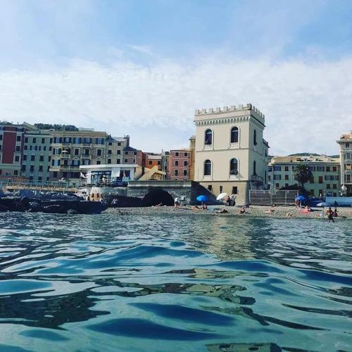 a view of a body of water with buildings at Hotel Castello Miramare in Genova