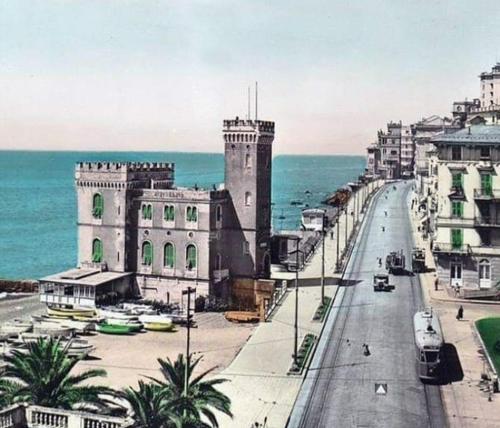 a view of a street with a building and the ocean at Hotel Castello Miramare in Genova