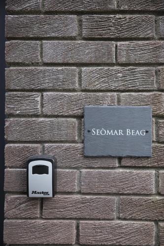 a brick wall with a toaster on a brick wall at Seòmar Beag in Oban