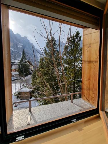 a window with a view of a snowy mountain at Hotel Borest in Colfosco