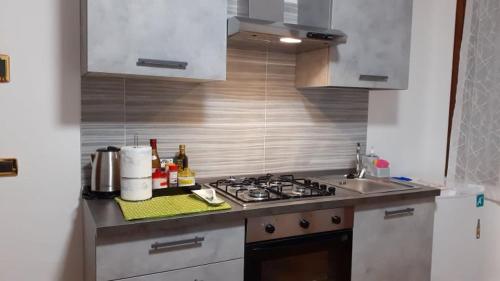 a kitchen with a sink and a stove top oven at Montegrappa Fly on in Crespano del Grappa