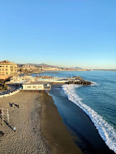 a view of a beach with a pier and the ocean at Hotel Castello Miramare in Genova