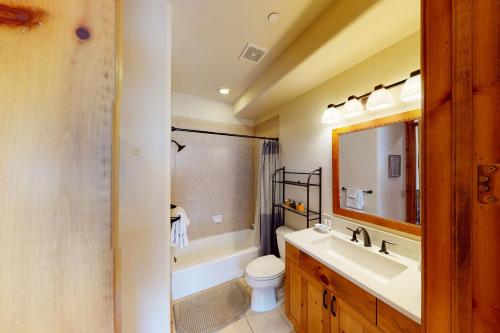 a bathroom with a sink and a toilet and a mirror at Sawatch Townhouse C8 in Edwards