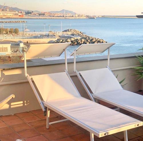 two beds on a balcony with a view of the ocean at Hotel Castello Miramare in Genova