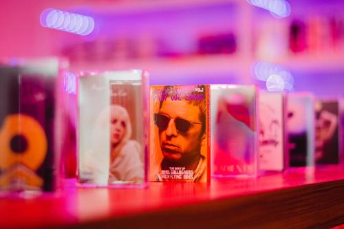 a row of canisters with a picture of a man with sunglasses at LIBERATED HOTEL Haruyoshi Kaichi in Fukuoka