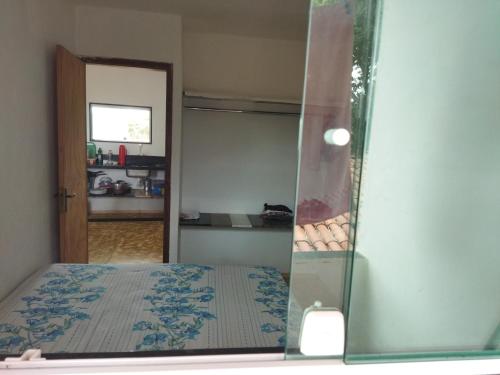 a reflection of a bedroom with a bed in a mirror at Apartamento in São José da Coroa Grande