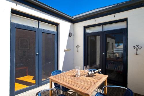 a wooden table and chairs on a patio at Port Boutique Accommodation in Port Fairy