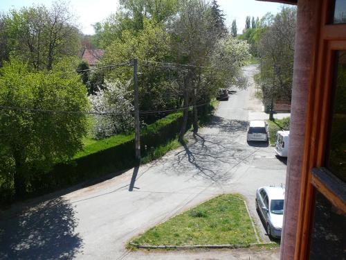 a view from a window of a street with cars parked at Porkoláb Apartmanház in Gyenesdiás
