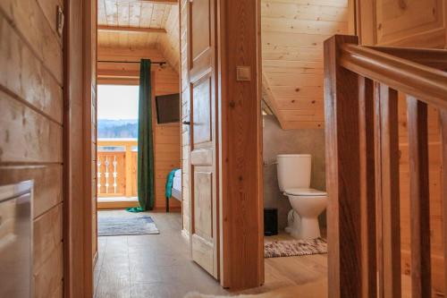 a bathroom with a toilet in a wooden house at Domki w górach "U Misia" in Jurgów
