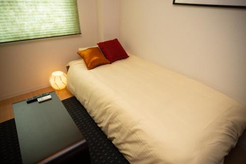 a bed with two pillows on it in a room at 唐沢ホテル Karasawa-Hotel in Tokyo