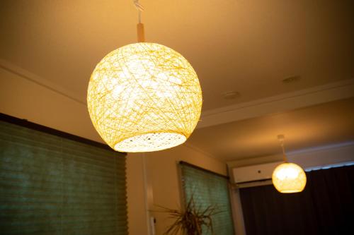 two lights hanging from the ceiling in a room at 唐沢ホテル Karasawa-Hotel in Tokyo