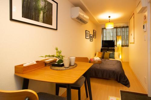 a room with a table and a bed and a bedroom at 唐沢ホテル Karasawa-Hotel in Tokyo