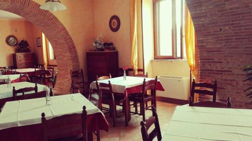 a restaurant with tables and chairs and a brick wall at Agriturismo Santa Barbara in Prignano Cilento