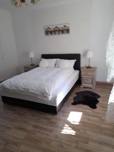a bedroom with a large bed and two night stands at Charming house "Luisi" in green garden Maribor 75m2 in Maribor